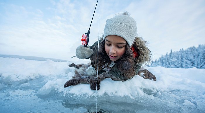 Girl ice fishing in Namdalen, Norway. Photo: Marius Rua/Buckethaus